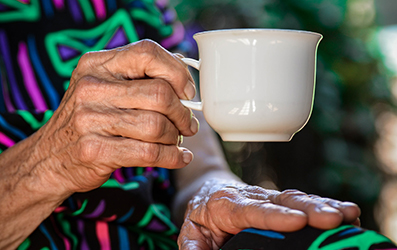 Elderly Lady Holding a Cup of Tea