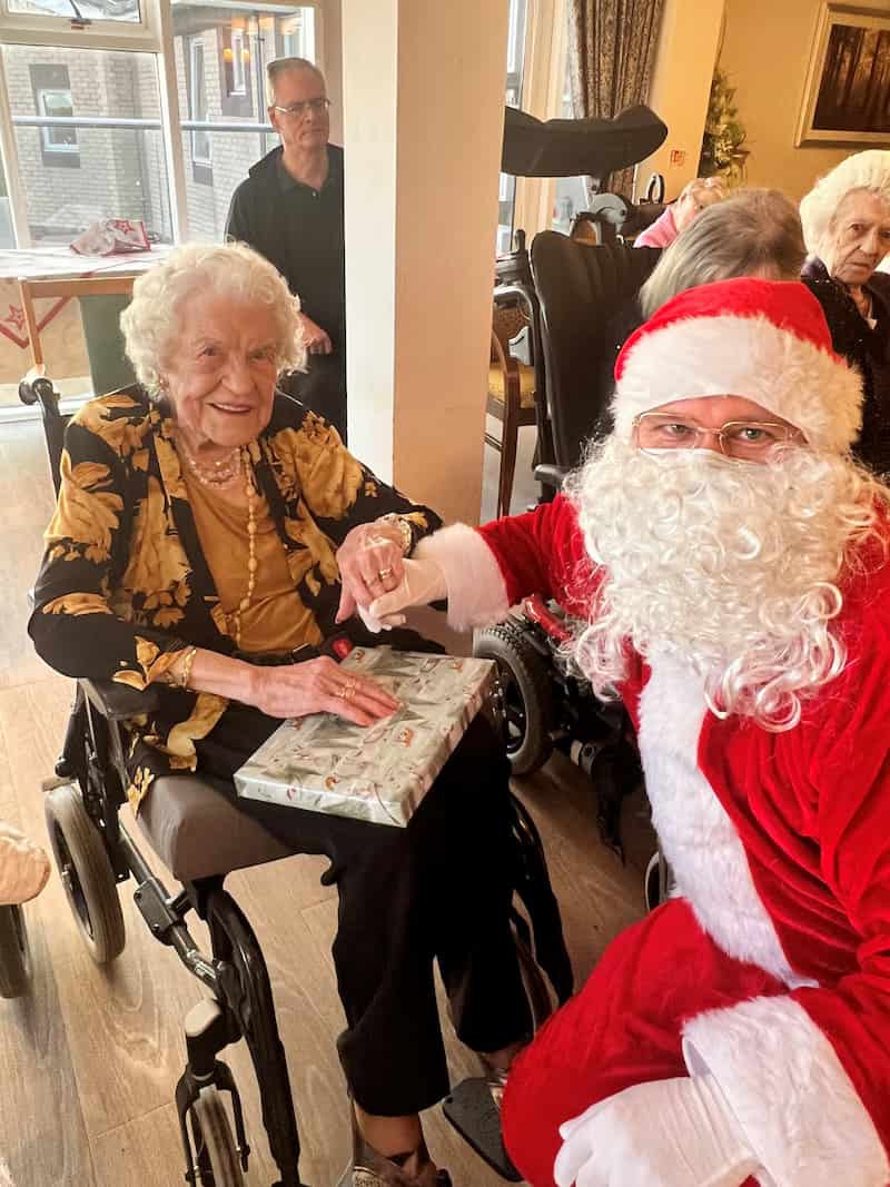 Resident Receiving Gift From Santa Claus