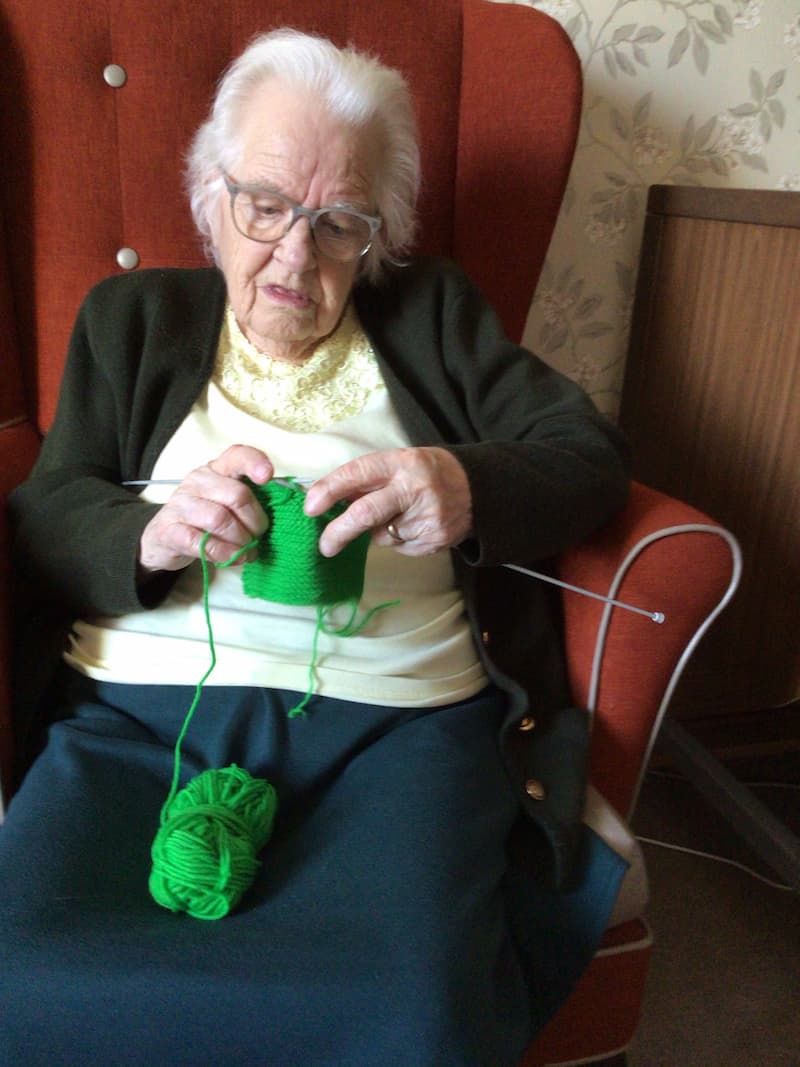 Resident Knitting in Chair