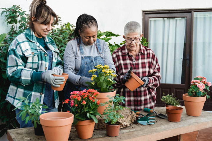 family members helping pot some plants in a care home