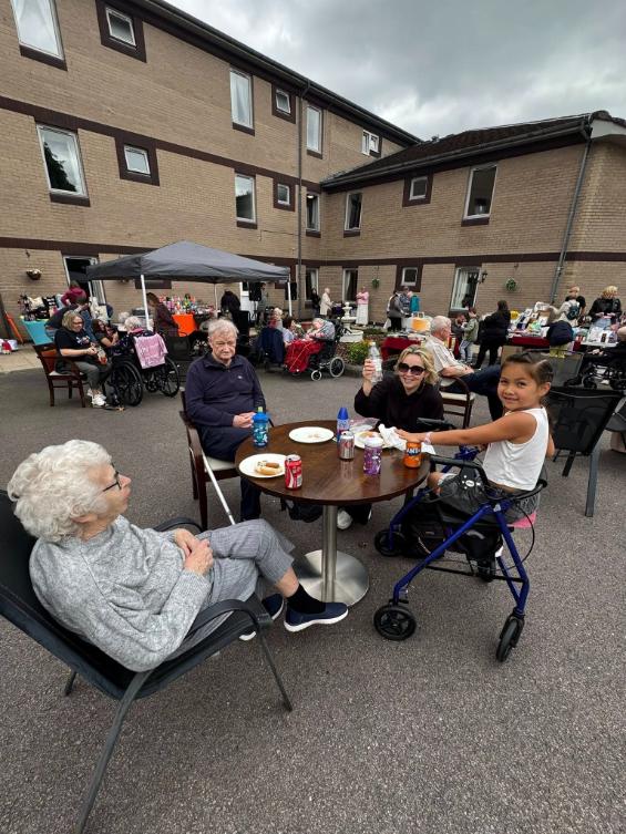 people sat around a table outside